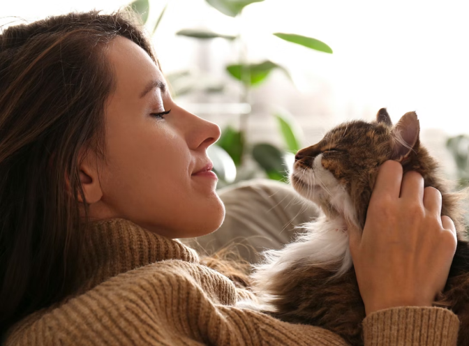 woman with cat laying on her chest