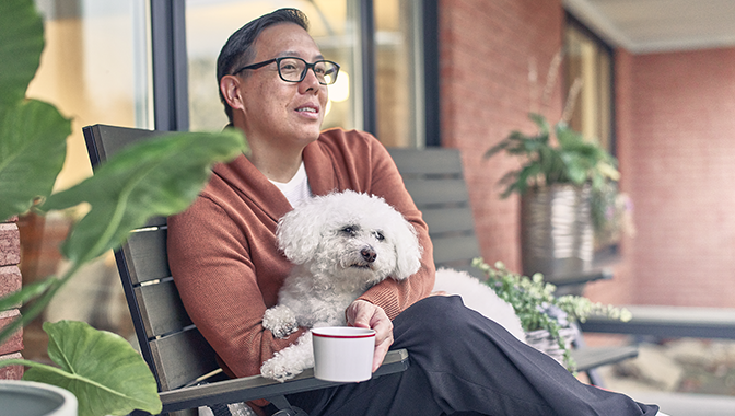 man with dog on a bench