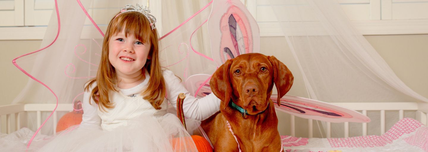 girl celebrating halloween with dog