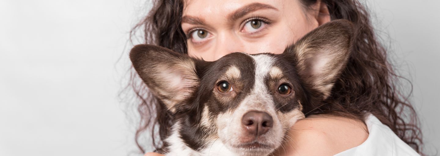 Woman carrying a dog