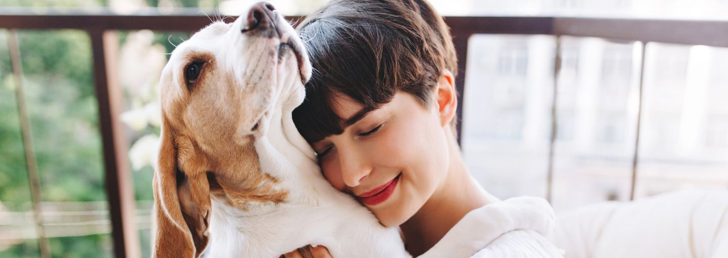 woman hugging a dog