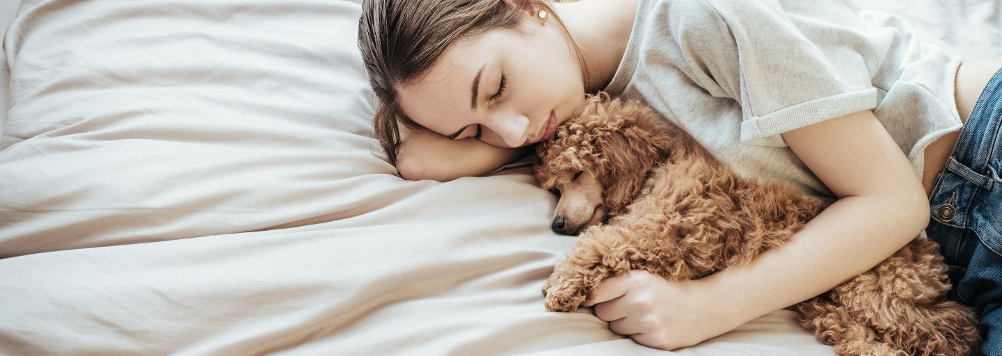 Owner in bed with her puppy